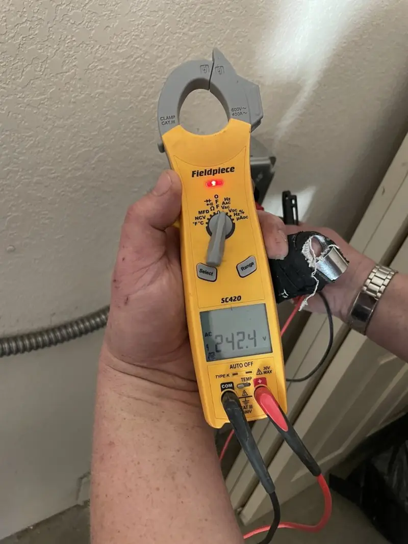 Voltage testing with clamp meter during Whole House Surge Protector in Talent